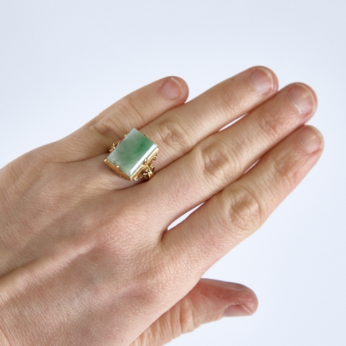 1315 - A late 20th century Chinese high carat gold jade panel ring, set with rectangular-cut jade panel wit... 