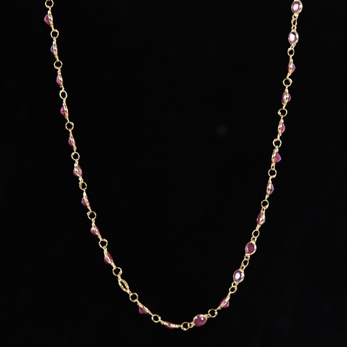 1316 - A modern handmade unmarked high carat gold ruby line necklace, set with round-cut rubies, necklace l... 