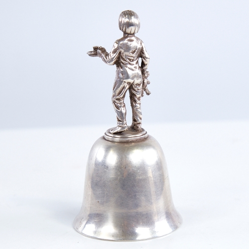 1319 - A late 20th century unmarked white metal dinner bell, figural design handle depicting boy with teddy... 