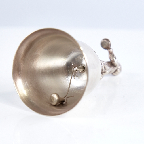 1319 - A late 20th century unmarked white metal dinner bell, figural design handle depicting boy with teddy... 