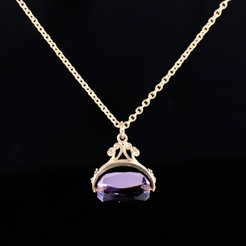 1326 - A late 20th century 9ct gold amethyst swivel fob pendant necklace, on unmarked gilt metal chain, pen... 