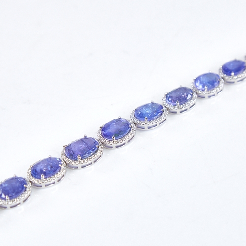 1329 - A modern platinum tanzanite and diamond cluster line bracelet, set with graduated panels of oval-cut... 