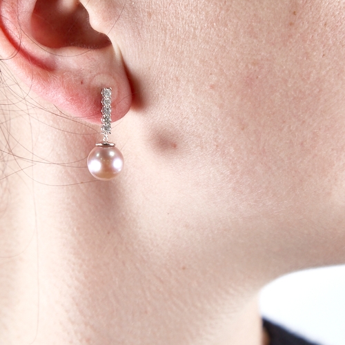 1332 - A modern pair of 14ct white gold pink South Sea pearl and diamond line earrings, total diamond conte... 