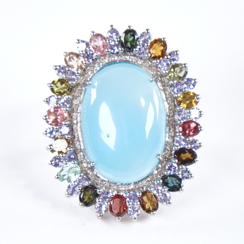 1333 - A large modern unmarked silver gem set ring, gemstones include cabochon turquoise, tourmalines and r... 