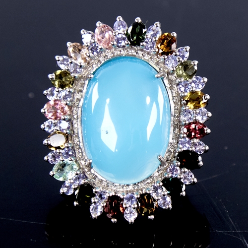 1333 - A large modern unmarked silver gem set ring, gemstones include cabochon turquoise, tourmalines and r... 