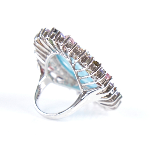 1333 - A large modern unmarked silver gem set ring, gemstones include cabochon turquoise, tourmalines and r... 