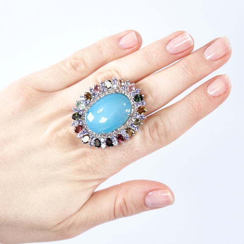 1333 - A large modern unmarked silver gem set ring, gemstones include cabochon turquoise, tourmalines and r... 