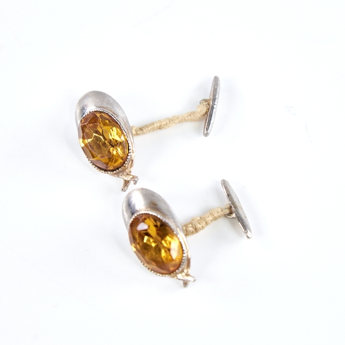 1336 - A pair of novelty unmarked white metal and citrine jockey cap cufflinks, cap length 32.5mm, and an u... 