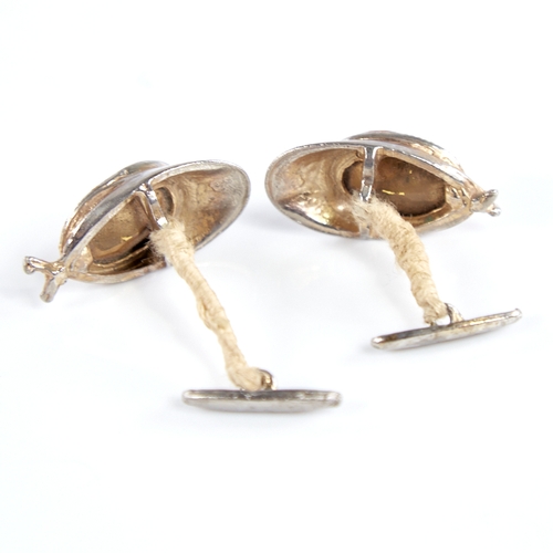 1336 - A pair of novelty unmarked white metal and citrine jockey cap cufflinks, cap length 32.5mm, and an u... 