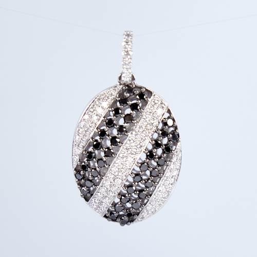 1337 - A modern 18ct white gold black and white diamond pendant, set with alternating stripes of round bril... 