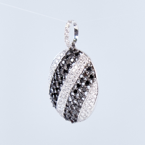 1337 - A modern 18ct white gold black and white diamond pendant, set with alternating stripes of round bril... 