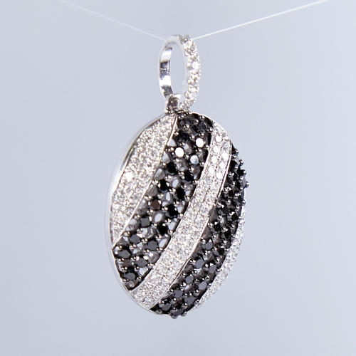 1337 - A modern 18ct white gold black and white diamond pendant, set with alternating stripes of round bril... 