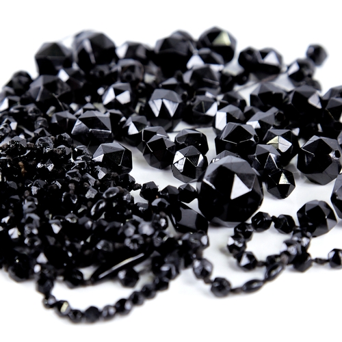 1345 - A group of faceted jet beads, largest diameter 21.2mm, 185g total