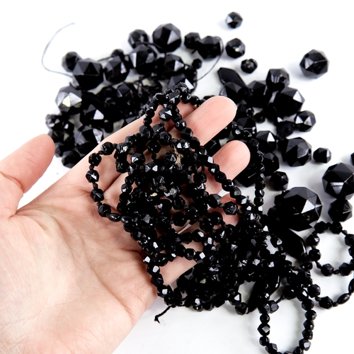 1345 - A group of faceted jet beads, largest diameter 21.2mm, 185g total