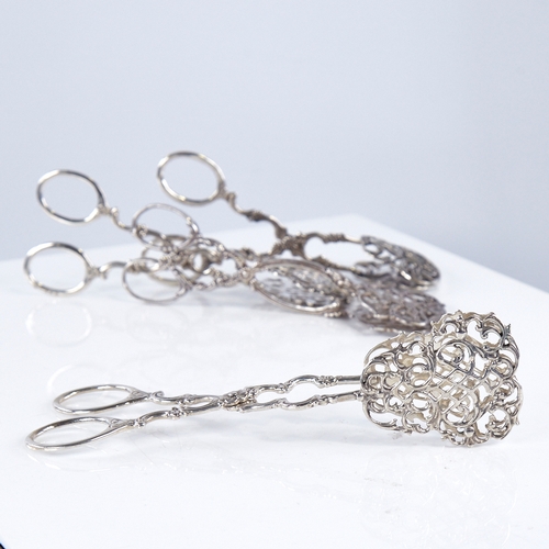 1351 - 4 pairs of Swedish silver pastry tongs, allover foliate decoration with pierced plates, largest leng... 