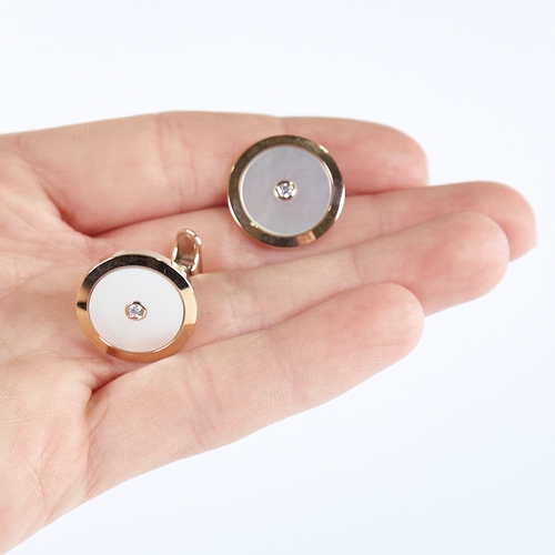 1362 - A modern pair of 18ct gold mother-of-pearl and diamond target panel cufflinks, total diamond content... 