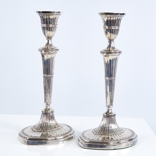 1367 - A pair of late Victorian silver table candlesticks, navette form with allover fluted decoration and ... 