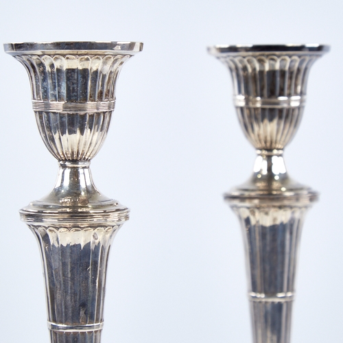 1367 - A pair of late Victorian silver table candlesticks, navette form with allover fluted decoration and ... 