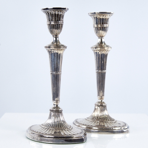 1367 - A pair of late Victorian silver table candlesticks, navette form with allover fluted decoration and ... 