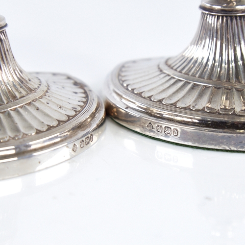 1367 - A pair of late Victorian silver table candlesticks, navette form with allover fluted decoration and ... 