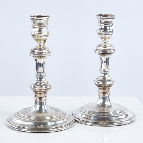 1368 - A pair of Elizabeth II silver table candlesticks, in George I style, by William Comyns & Sons Ltd, h... 