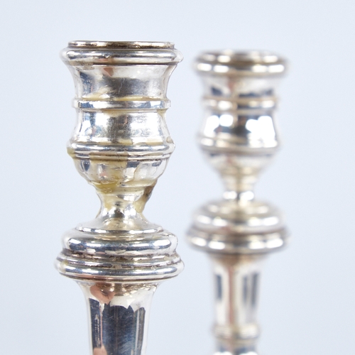 1368 - A pair of Elizabeth II silver table candlesticks, in George I style, by William Comyns & Sons Ltd, h... 