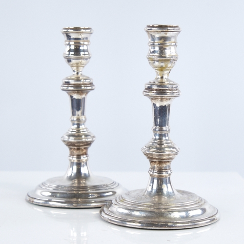 1368 - A pair of Elizabeth II silver table candlesticks, in George I style, by William Comyns & Sons Ltd, h... 