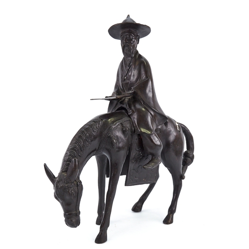 315 - A Chinese patinated bronze horse and rider, height 35cm