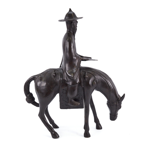 315 - A Chinese patinated bronze horse and rider, height 35cm