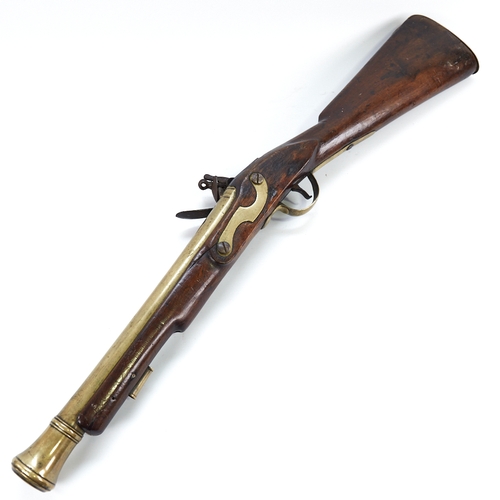 318 - A 19th century flintlock brass-barrelled blunderbuss, with mahogany stock, impressed marks to the ba... 