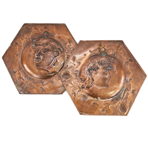 319 - A pair of Art Nouveau copper plaques, relief embossed portrait panels in scroll surrounds, 37cm acro... 