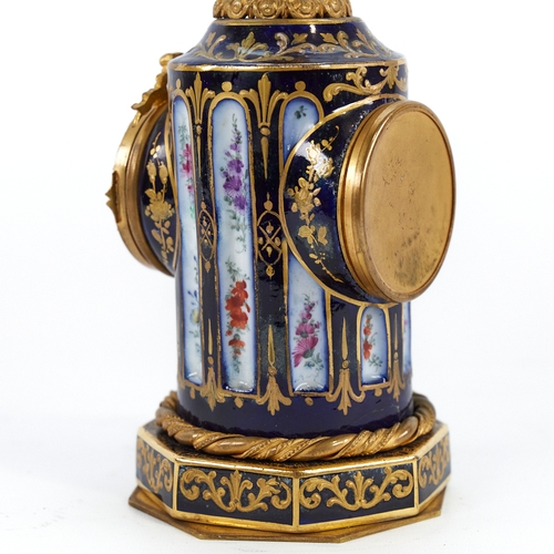 320 - A French blue and gilt porcelain-cased mantel clock in the form of a column, surmounted by a gilt-br... 