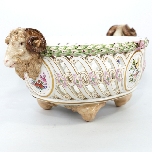 322 - A Meissen Porcelain table centre basket, circa 1900, with ram's head handles, pierced surround and h... 