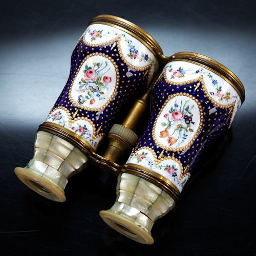 324 - A pair of French enamelled opera glasses, hand painted floral decoration on blue and gilt ground, wi... 