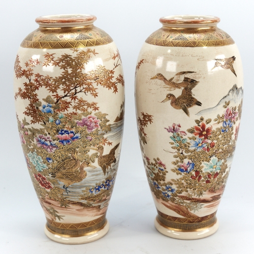 329 - A pair of Japanese Satsuma porcelain vases, with painted and gilded birds and trees, signed under ba... 