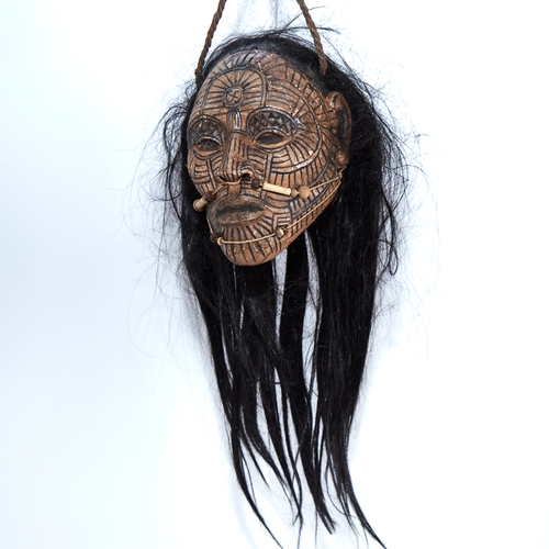 338 - An unusual composition Tribal head wall mask, with painted face and real hair, life-size, probably m... 