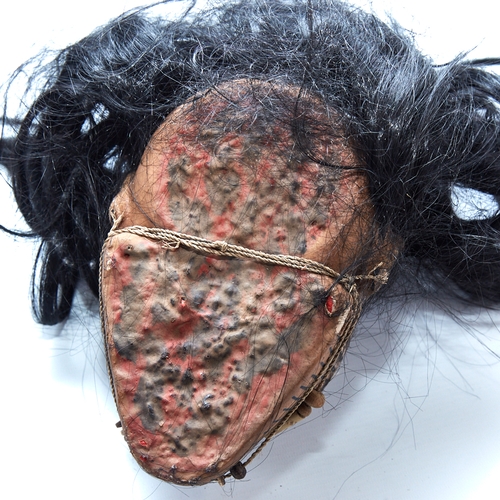 338 - An unusual composition Tribal head wall mask, with painted face and real hair, life-size, probably m... 