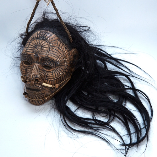 338 - An unusual composition Tribal head wall mask, with painted face and real hair, life-size, probably m... 