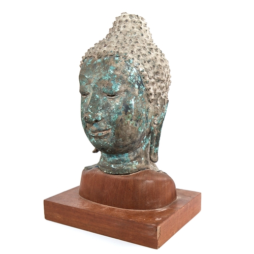 341 - A Chinese verdigris bronze Buddha head, probably 17th or 18th century, mounted on modern woodblock p... 