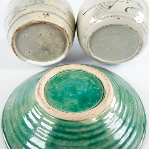 347 - A Chinese green glaze pottery bowl with central text panel, diameter 24cm, and a pair of blue and wh... 