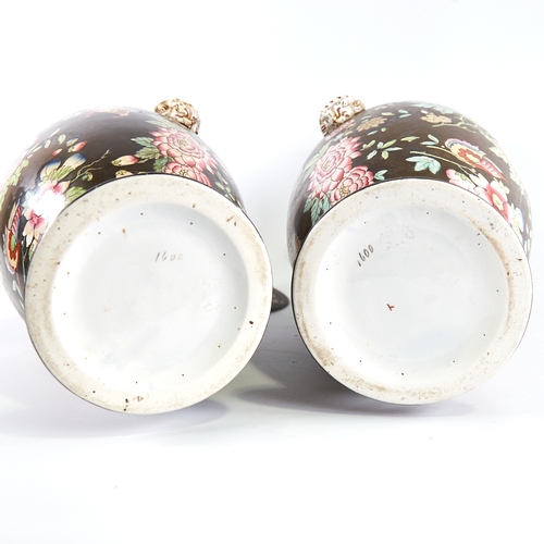 350 - A pair of 19th century porcelain vases and covers, with enamel decoration and gilded ram's head hand... 