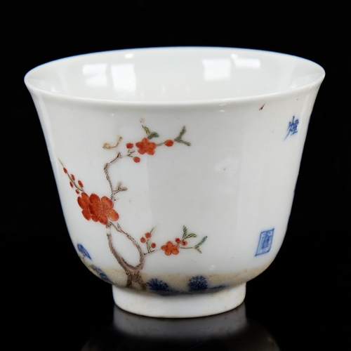 368 - A Chinese porcelain tea bowl, with painted blossom tree and text, 6 character mark, diameter 6.5cm, ... 