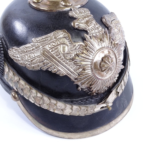 243 - A reproduction German leather and nickel plate mounted helmet