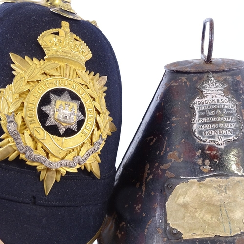 245 - East Surrey Regiment military helmet with gilt-brass crest and brass-mounted chin strap, in tin case