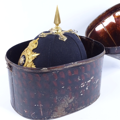 245 - East Surrey Regiment military helmet with gilt-brass crest and brass-mounted chin strap, in tin case