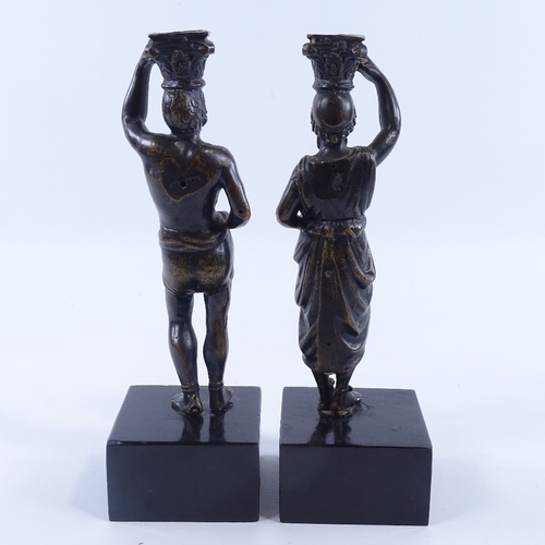 227 - A pair of patinated bronze candleholders, in the form of Greek Classical figures, late 19th century,... 