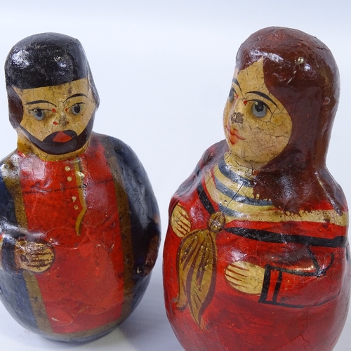 232 - A pair of unusual German Folk Art roly poly figures, circa 1850, weighted papier mache with hand pai... 