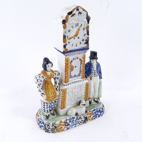 108 - A rare Yorkshire Pratt Ware longcase clock group moneybox, flanked by a pair of figures and a dog in... 