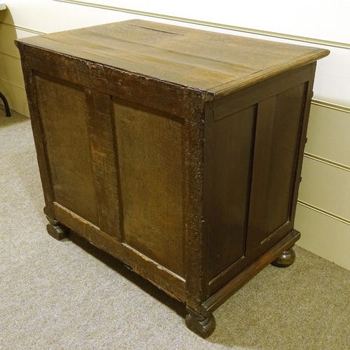 121 - A 17th century joined oak chest of 4 long graduated drawers, with panelled drawer fronts, brass drop... 