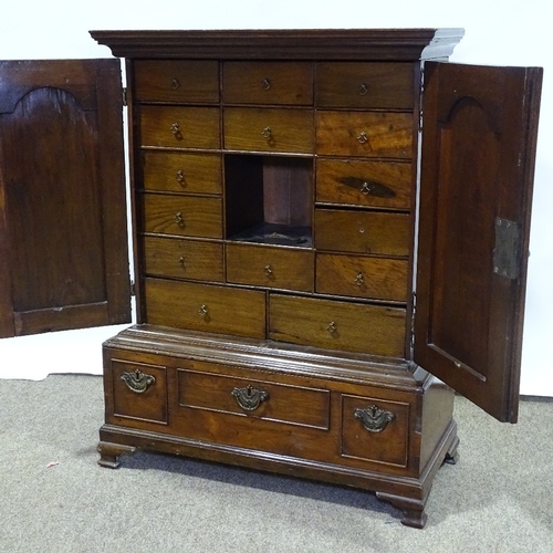 310 - A Georgian mahogany collector's cabinet of small size, with 2 fielded arch panelled doors enclosing ... 